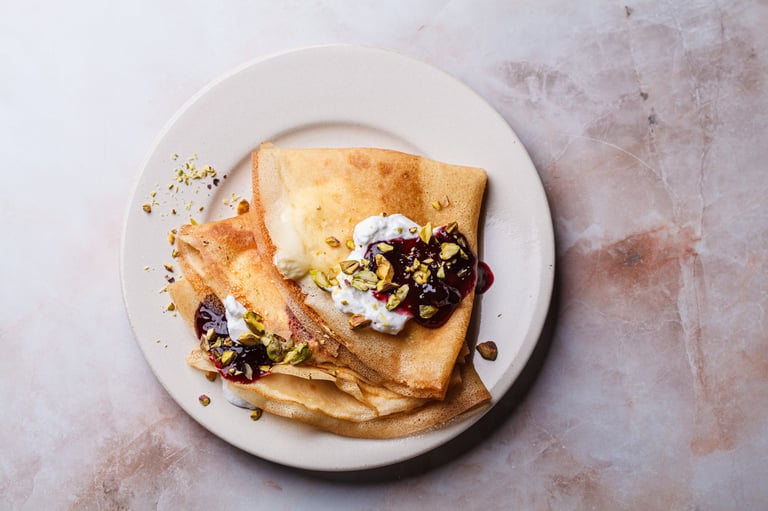 Breakfast crepes with sour cream and pistachio