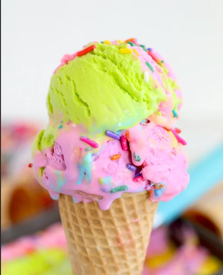 Colorful ice cream cone with neon yellow and pink scoops topped with rainbow sprinkles
